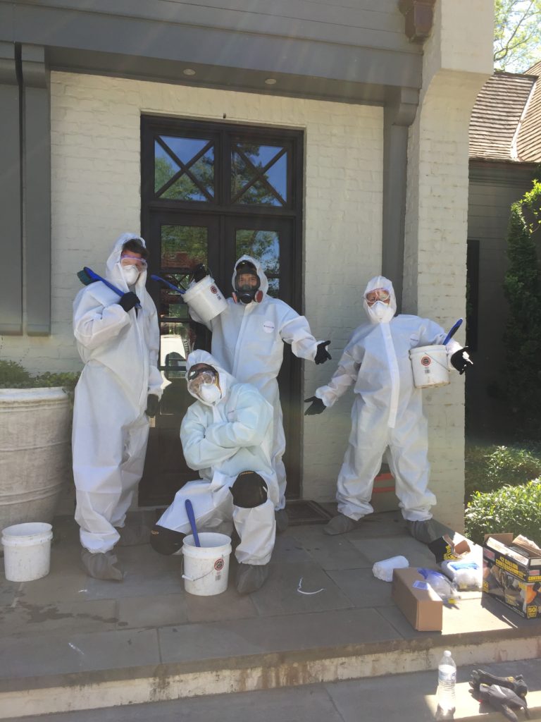 The Solutions Group crew in Tyvek suits and respirator masks. They're at home to complete a mold remediation project.