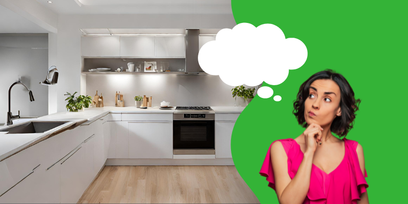 A modern, spacious kitchen with white cabinetry, stainless steel appliances, and light wooden flooring. On the right, a woman in a bright pink top appears deep in thought, with a contemplative expression and her hand on her chin. A large thought bubble emanates from her head, suggesting she is dreaming or considering ideas for home renovations, rebuilds, or remodels.
