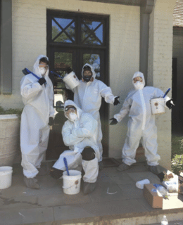 The Solutions Group crew in Tyvek suits and respirator masks. They're at home to complete a mold remediation project.